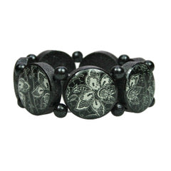 Wooden bracelet with silver pigments and black lace motifs