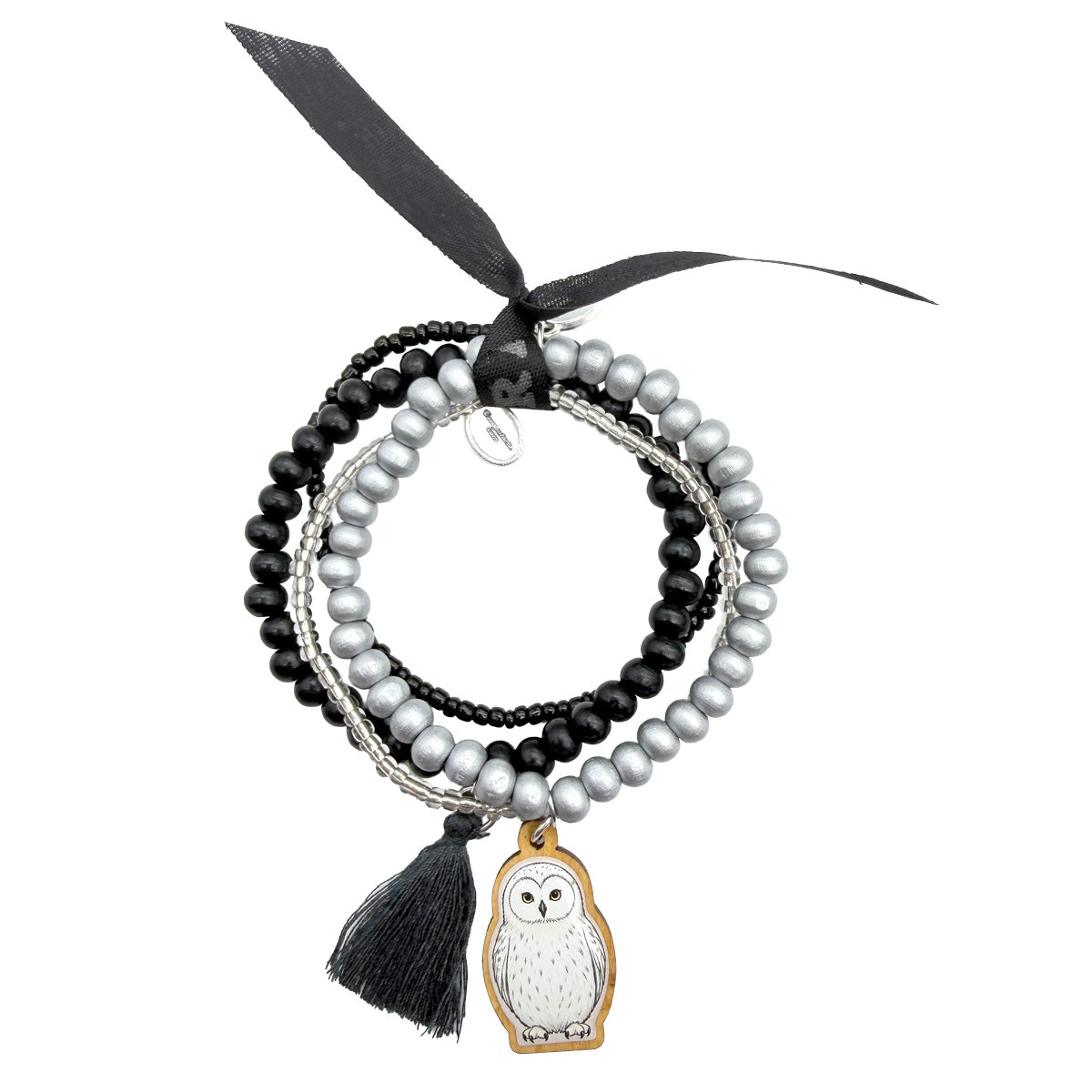 Escapulario Armbandset mit Holzpin Schneeeule, schwarzen und silberfarbenen Holzperlen, feinen Glasperlen, schwarzer Quaste und schwarzem Bonfimband.
