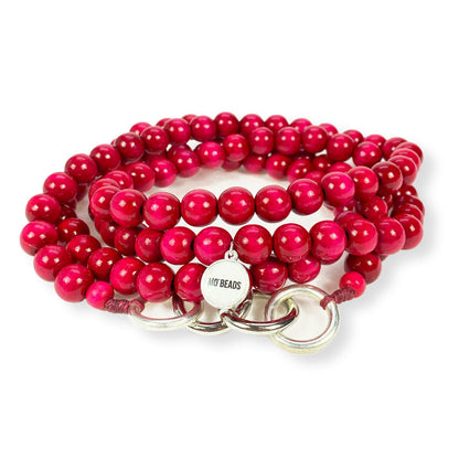 Escapulario Handykette in Pink mit leuchtenden Perlen und Metallkarabinern als verspieltes Handyband für Frauen.